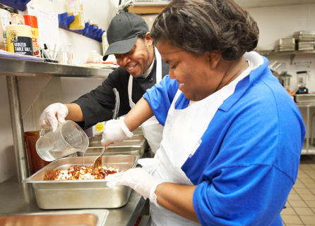 Two food services employees at work