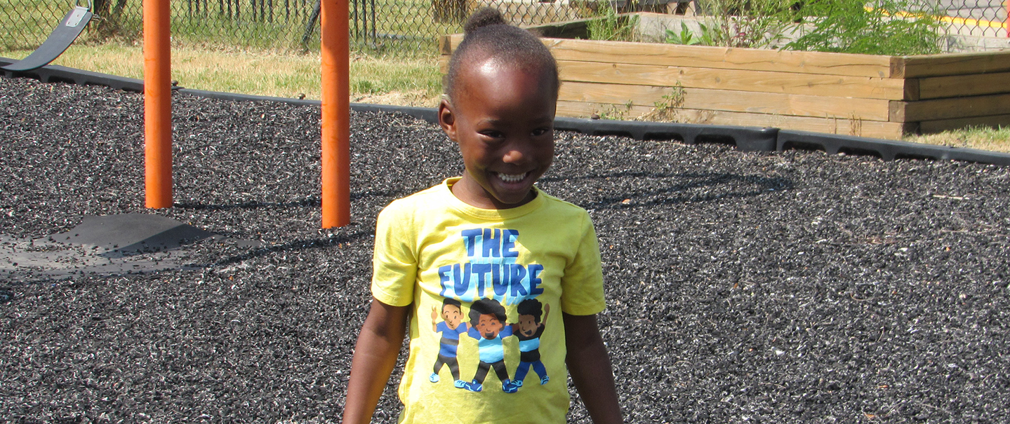 kiddo smiling wearing a the future t-shirt
