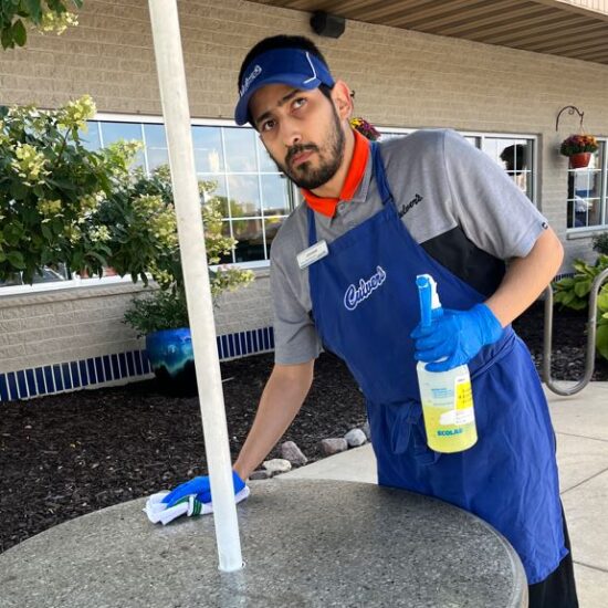Johnny cleans a table at Culvers