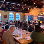 Guest at Braise dinner sitting down at tables