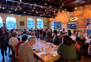 Guest at Braise dinner sitting down at tables