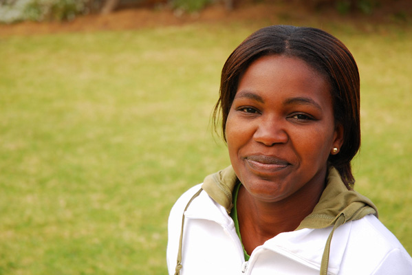 Woman smiling outside with in grassy area